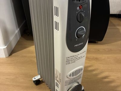Pelonis Oil-Filled Radiator Space Heater with Adjustable Thermostat and Wheels, White