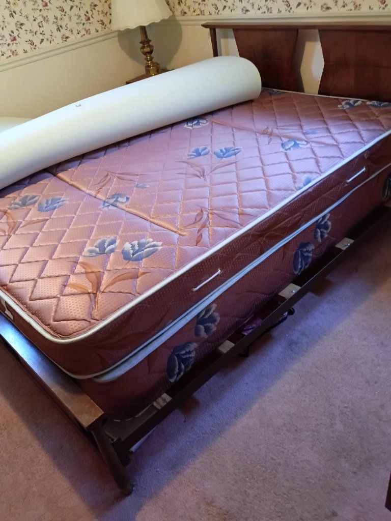 full size bed frame with mattress, box spring, and foam topper set.