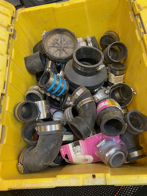 Many buckets & bins of plumbing supplies