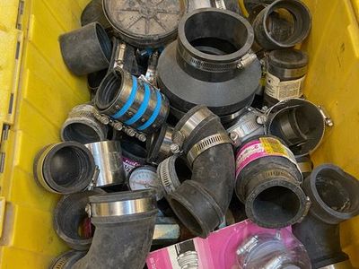 Many buckets & bins of plumbing supplies