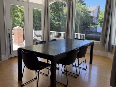 Modern Dark Wood Dining Table - Seats 6-8, Extendable Leaf, Includes 6 Black Chairs