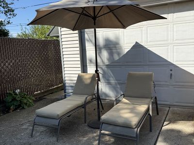 Patio furniture, 2 loungers with cushions and umbrella with weighted stand