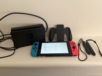 Nintendo Switch Console with Neon Red & Blue Joy-Cons, Dock, and Joy-Con Grip