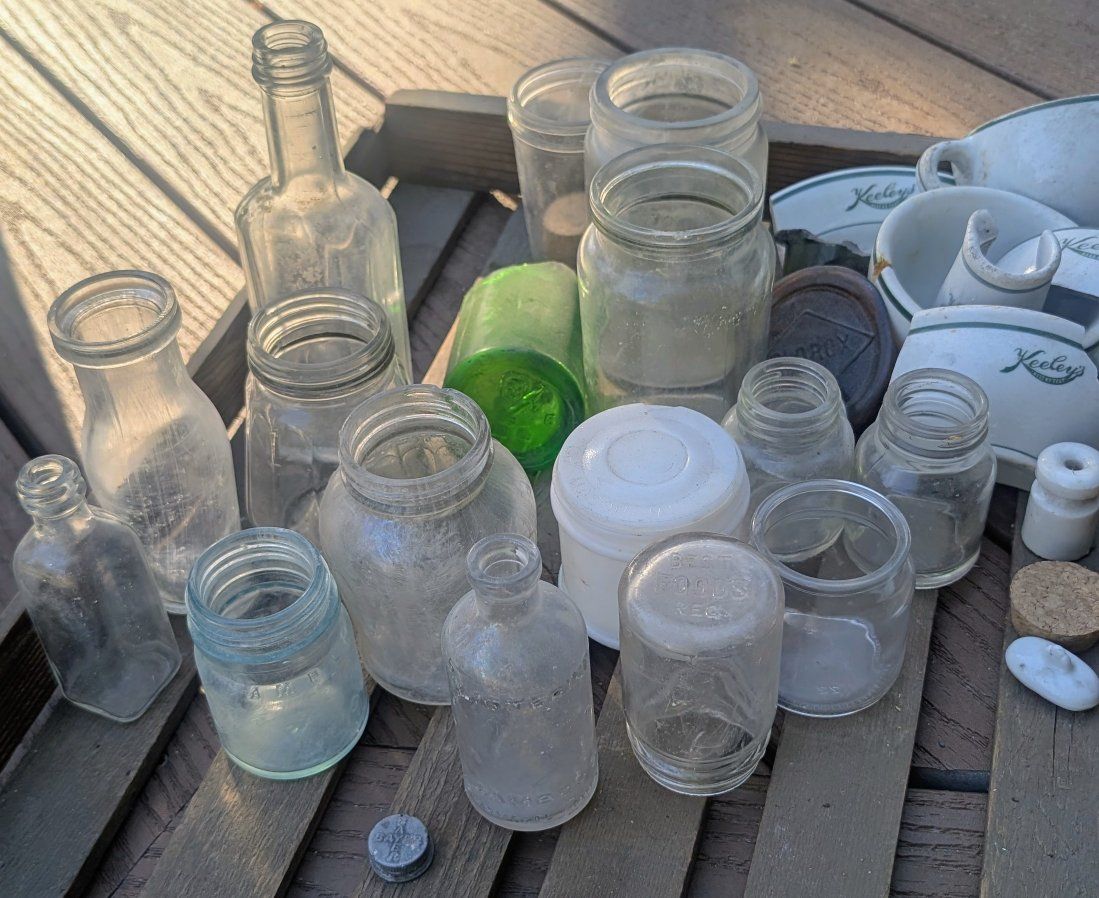Antique bottles, oil can pump, light shade, pulleys, door pull handle, etc.