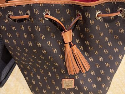 Dooney & Bourke Monogram DB Print Bucket Bag Purse with Tassels
