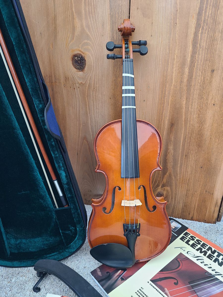 Violin with: book, rosin and a shoulder rest