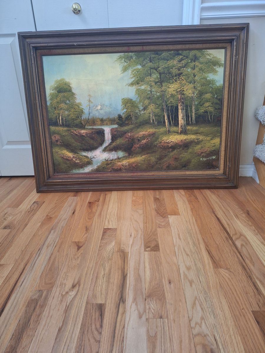 Vintage framed oil landscape painting featuring a forest waterfall scene. 44" wide x 32.5" tall.