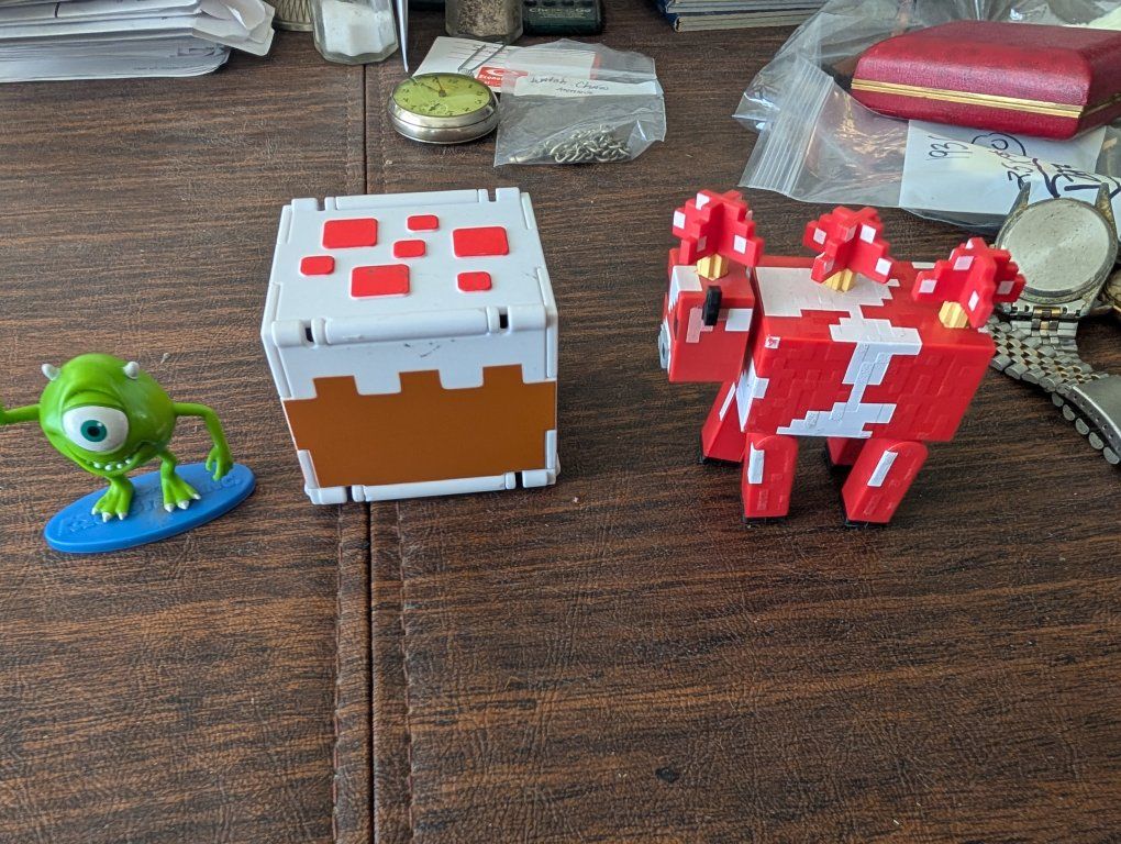 Michael Wazowski green guy and a Mattel cow