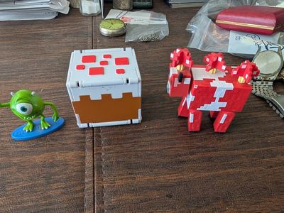 Michael Wazowski green guy and a Mattel cow