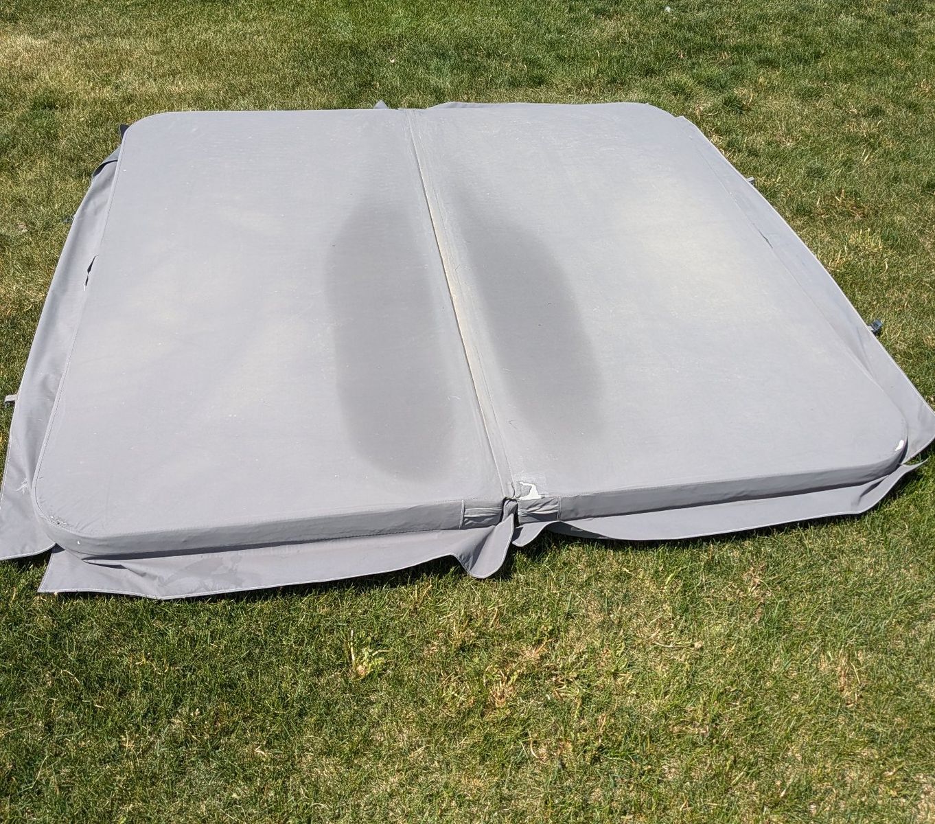 used hot tub cover, 93x94 inches with rounded corners. fabric cover, minor tears with no water intrusion into foam.