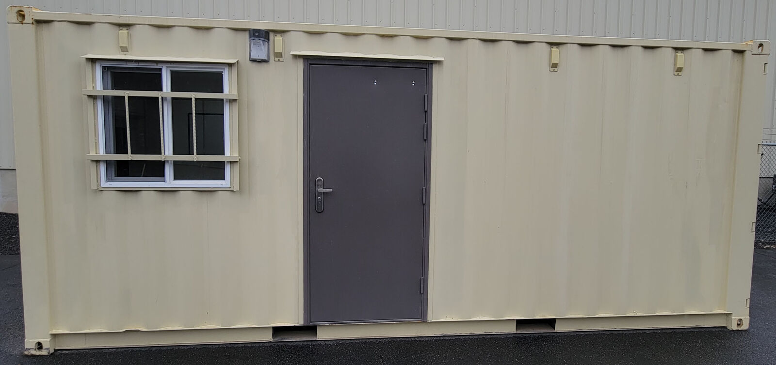 Container construction jobsite office with storage garage