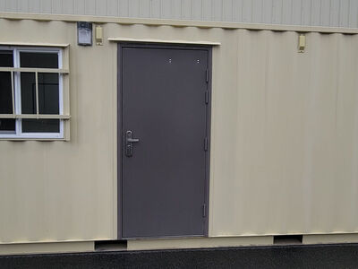 Container construction jobsite office with storage garage