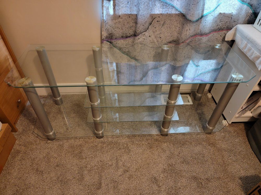 Modern glass console table with metal legs.