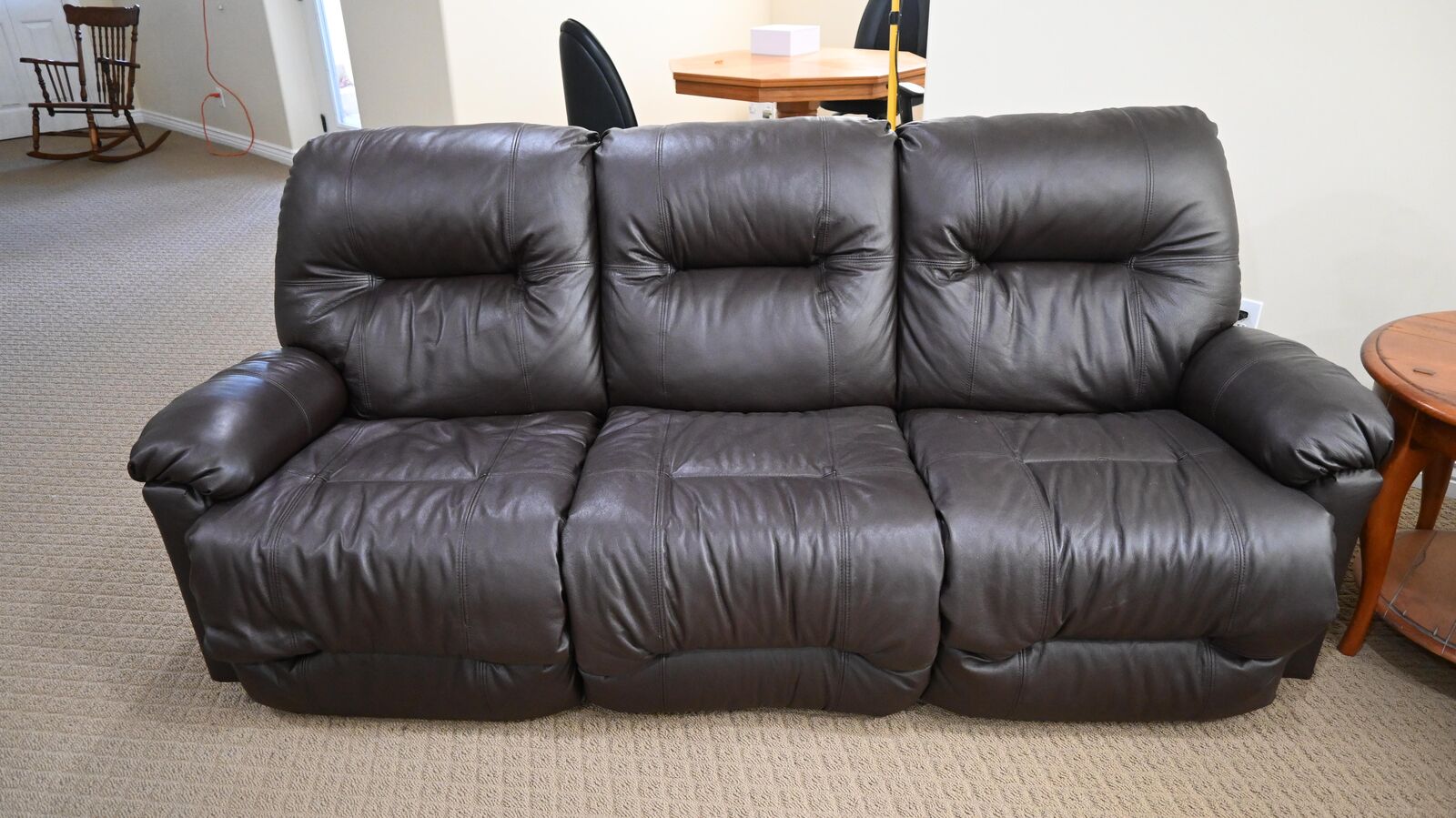 Dark brown leather sofa with a recliner on each end