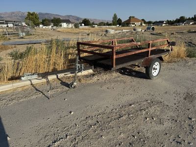 Small Utility Trailer - Single Axle, Steel Grate Bed, Rust Present - Ideal for Hauling or Farm Use