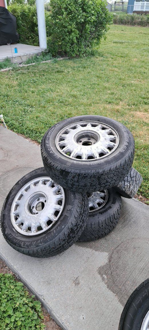 4 aluminum wheels with used tires