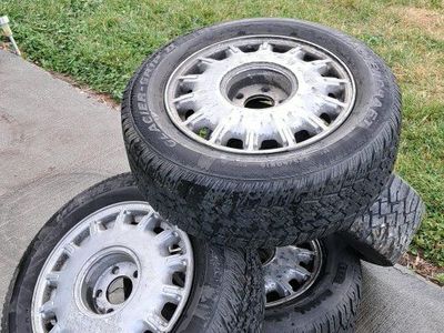 4 aluminum wheels with used tires