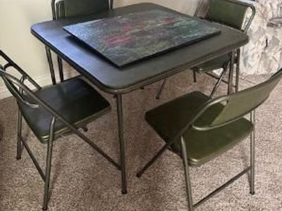Green card table with four chairs