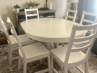 White wooden dining room set with 6 chairs
