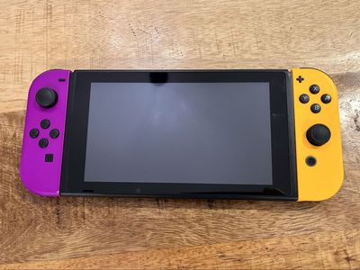 Nintendo Switch v2 with Neon Purple & Orange Joy-Cons + 4 Games Bundle