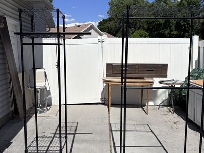 Black Steel Freestanding Adjustable Clothes Rack With Shelves And Rods.