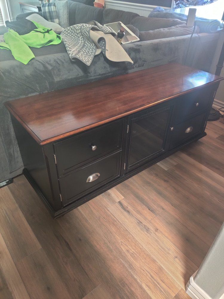 Spacious Black TV Stand with Cherry Wood Top, Glass Doors & Storage Drawers