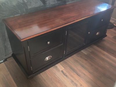 Spacious Black TV Stand with Cherry Wood Top, Glass Doors & Storage Drawers