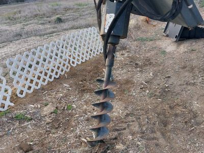 Bob Cat post hole digger