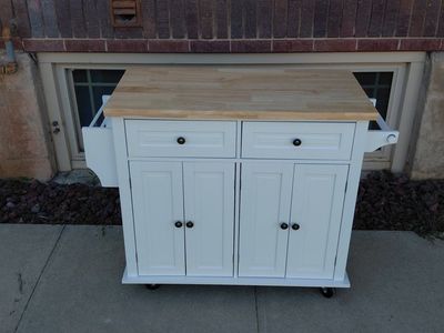 Rolling kitchen cabinet with solid wood countertop.