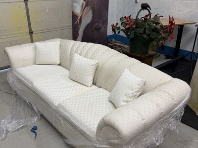 Cream Tufted Fabric Sofa with Rolled Arms and Matching Pillows
