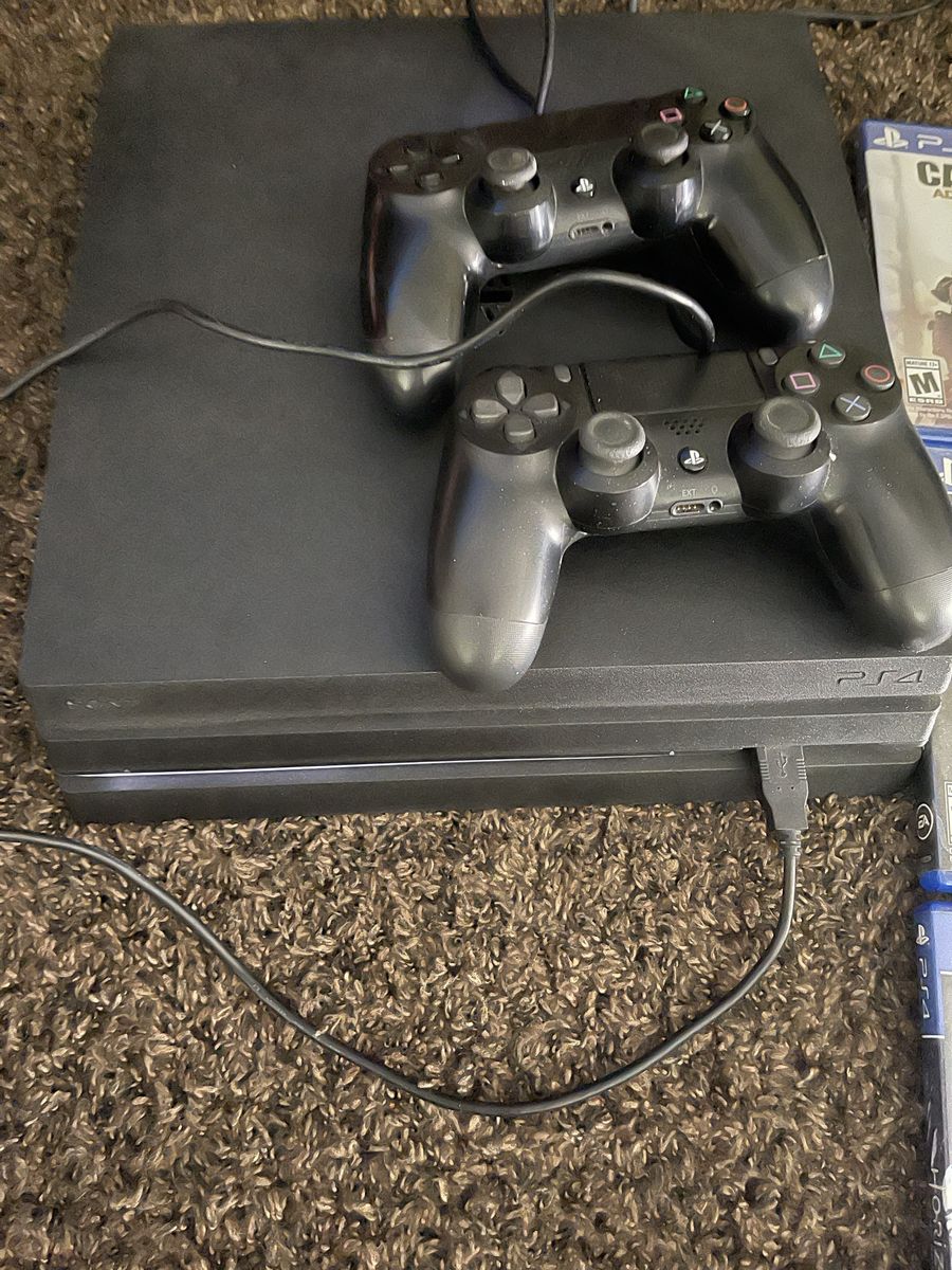 PlayStation 4 Pro with 2 controllers and 9 games