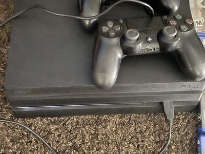 PlayStation 4 Pro with 2 controllers and 9 games