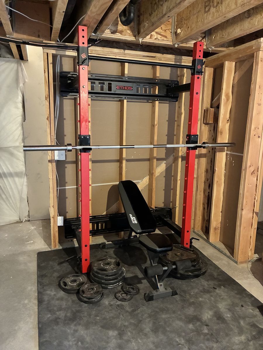 Ethos Wall-Mounted Folding Squat Rack w/ Adjustable Bench & Weights