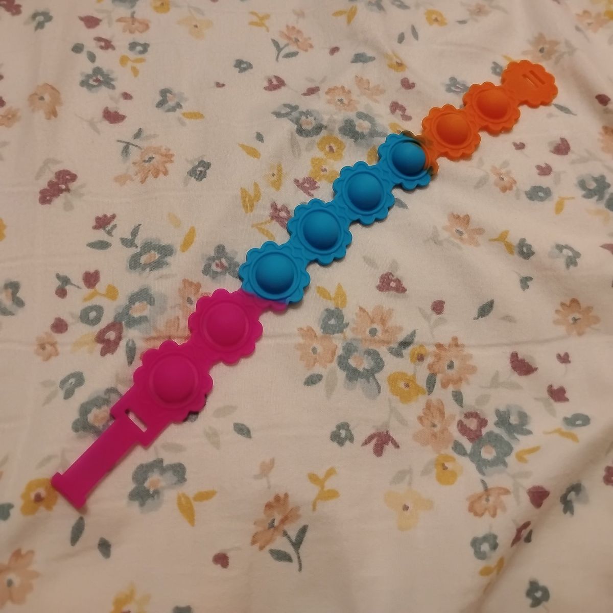pink and blue and orange bracelet pop it