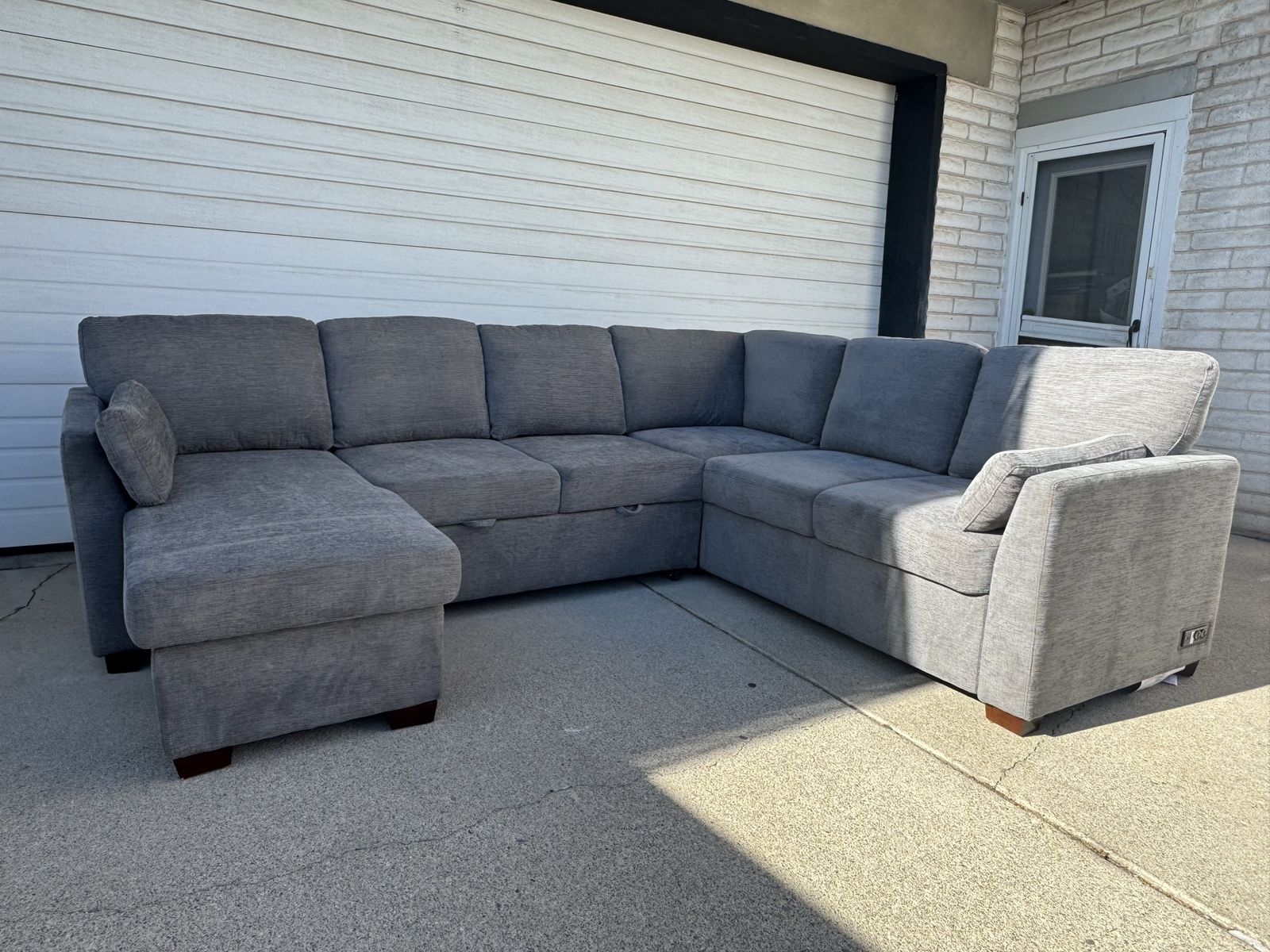 Spacious Gray Sectional Sofa with Storage Chaise and Pull-Out Bed - Excellent Condition