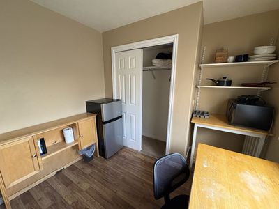 Fully furnished room with fridge and kitchenette