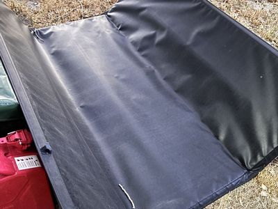 Used Truck Bed Cover Tonneau Black Foldable. Used on Ram 1500. (Condition: UsedFair)