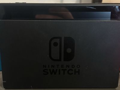 Nintendo Switch w/ joy cons, charging cable, dock, and carrying case.