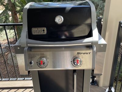 Weber Sprit BBQ with propane tanks