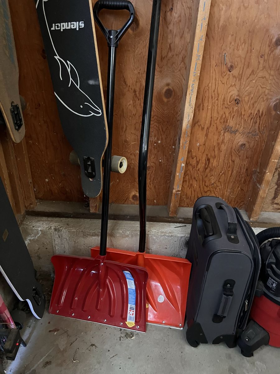 Two Snow Shovels Red and Orange with Black Handles
