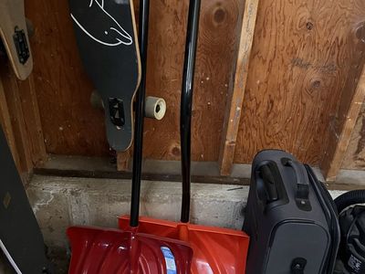 Two Snow Shovels Red and Orange with Black Handles