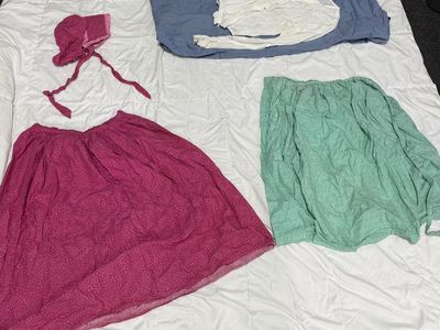 Dark pink pioneer skirt with matching bonnet, white blouse, and cute mint green apron.
