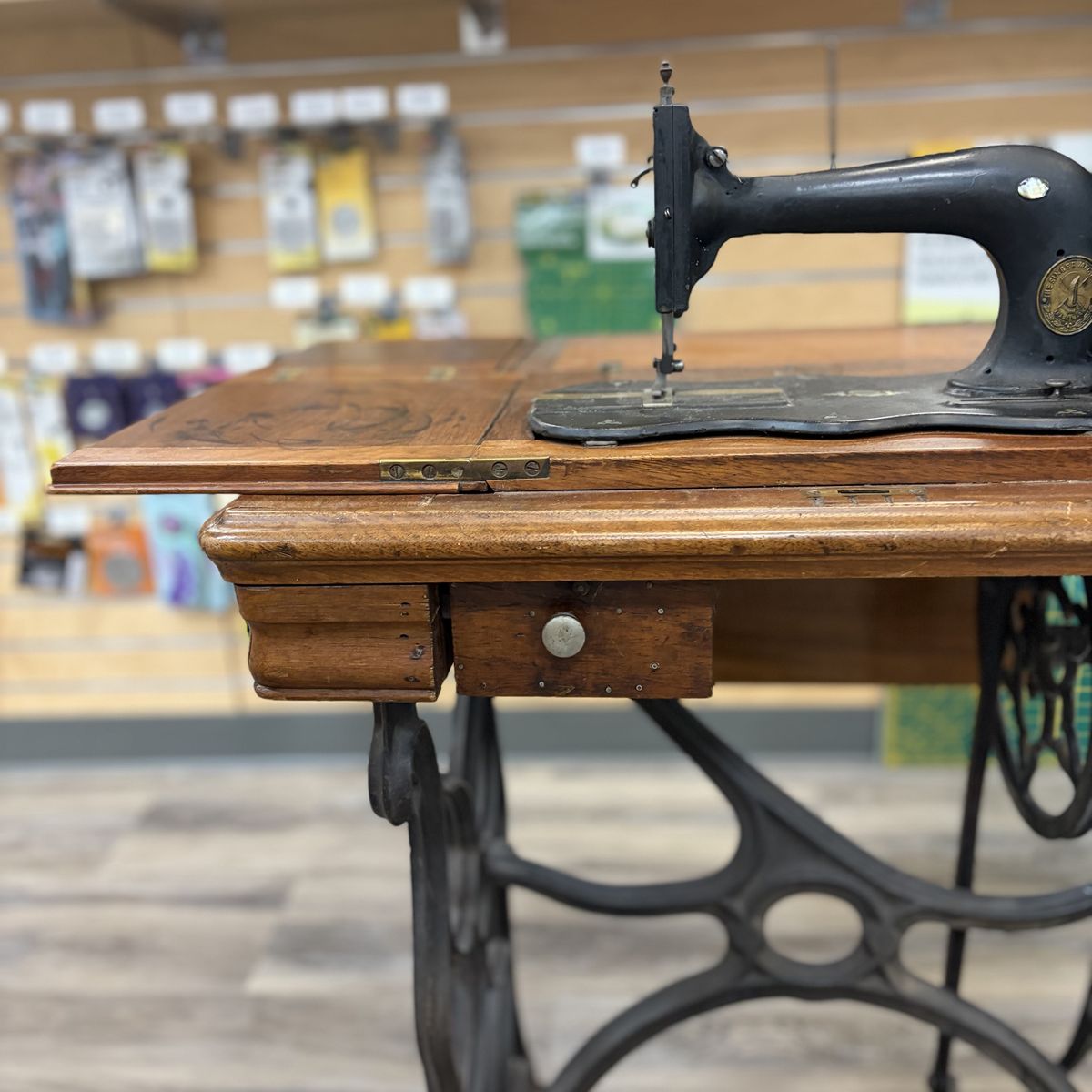 Antique Singer Treadle Sewing Machine with Ornate Cast Iron Base and Wood Cabinet. Built in 1868 in New York, Mother of Peal