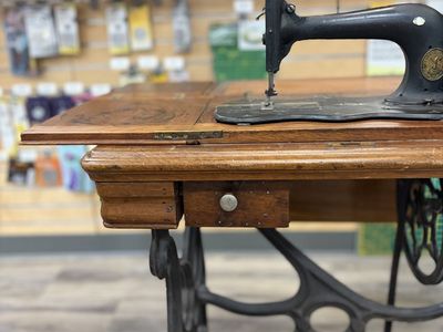 Antique Singer Treadle Sewing Machine with Ornate Cast Iron Base and Wood Cabinet. Built in 1868 in New York, Mother of Peal