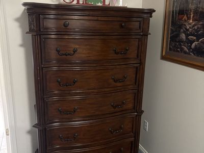 Dark Wood Tall Dresser with Multiple Drawers and Ornate Hardware