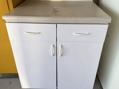 White Kitchen Cabinet with Countertop and Drawers used in garage as shelving
