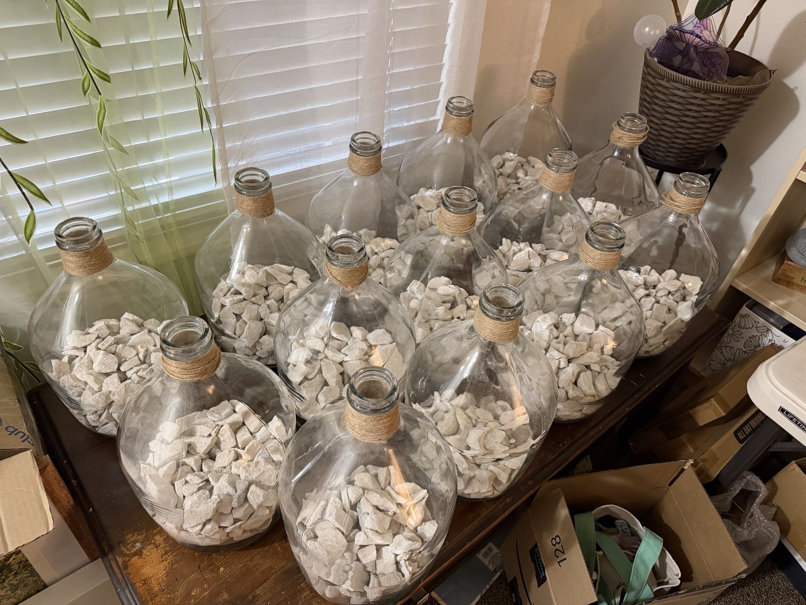 Large Clear Glass Demijohn Carboy Bottle with Jute Rope Detail and Decorative White Rocks