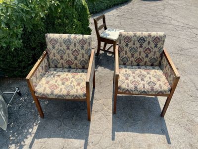 Pair of mission-style vintage chairs featuring geometric tapestry upholstery and solid wood frame