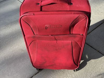 Red 4-wheeled suitcase