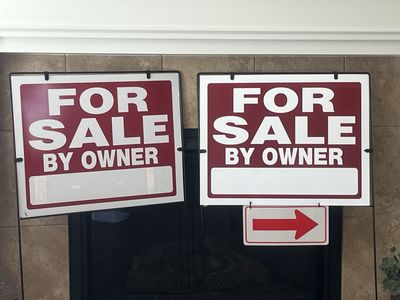 Two for sale by owner signs